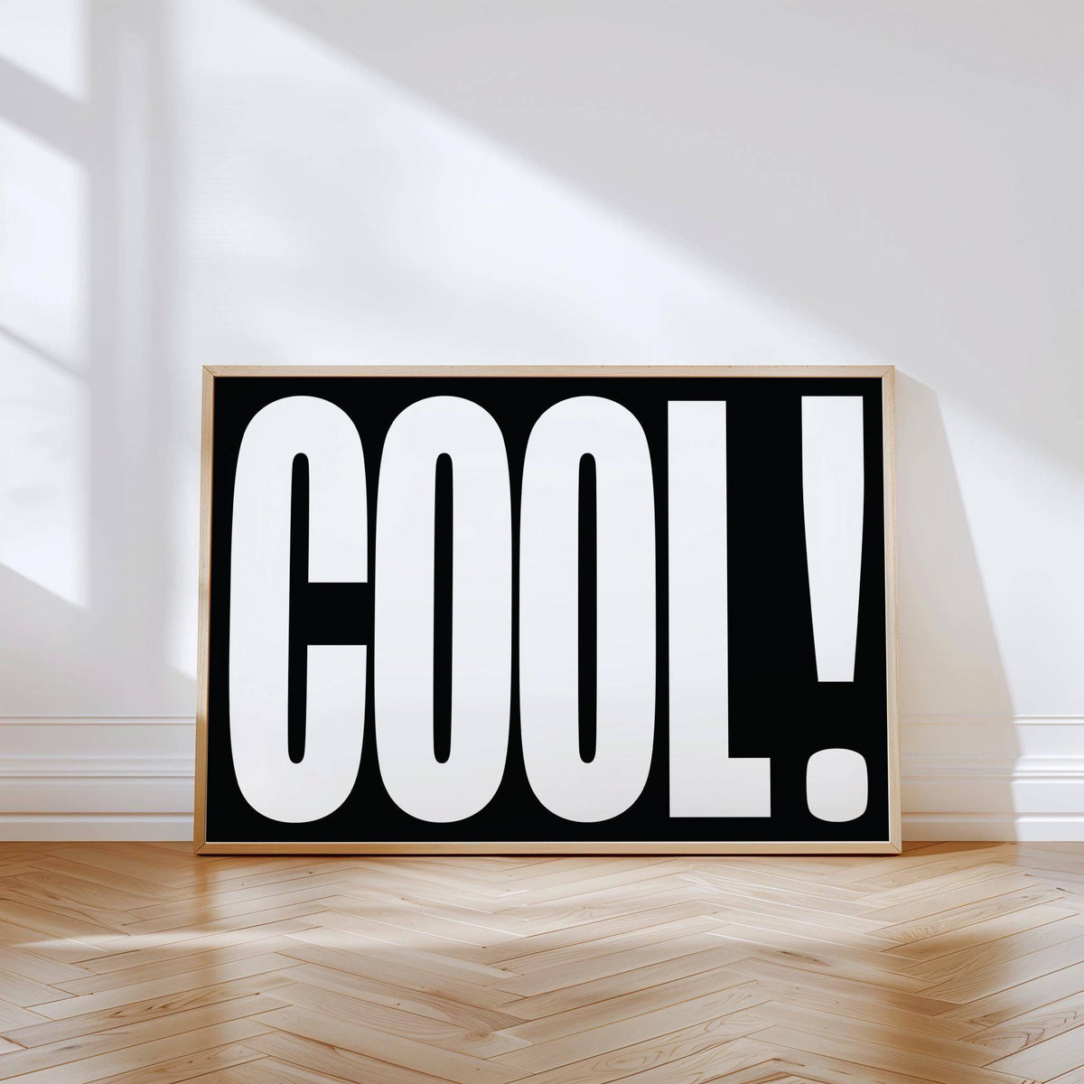 Cool Typography Art print with bold white letters on black leaning on a wooden parquet floor