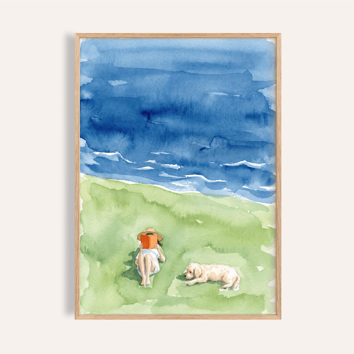 Framed print of a person reading with a dog beside them in watercolour style with blue and green hues