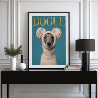 Fashion Dog Poster print of a grey dog in a white knit hat with pom poms on a blue background on a black sideboard with a lamp