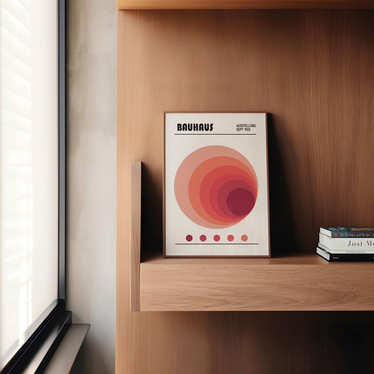 Wall Art Office leaning print with concentric circles in red and pink shades beside a window