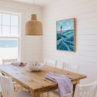 Modern Lighthouse Art print with a pink lighthouse and swirling blues in a white dining room