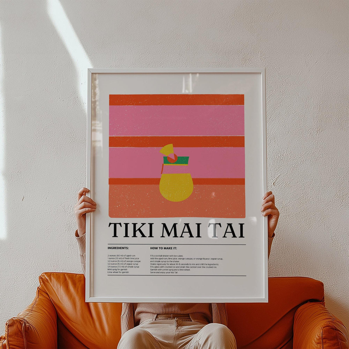 Bar wall art showing a tiki mai tai cocktail illustration with pink and orange stripes held in hands above an orange sofa