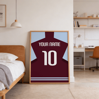 Football Shirt Poster in Claret with Light Blue Sleeves leaning against a wall near a wooden bed in a bedroom