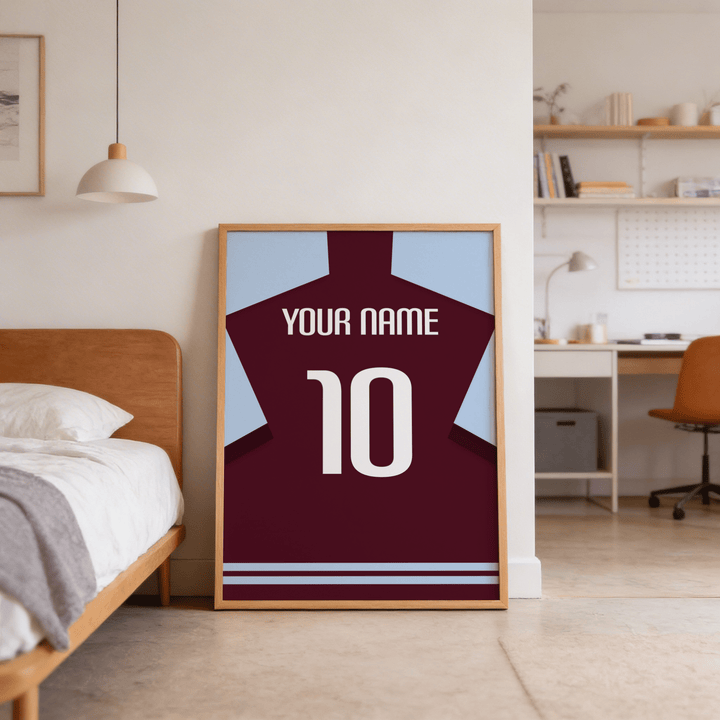 Football Shirt Poster in Claret with Light Blue Sleeves leaning against a wall near a wooden bed in a bedroom