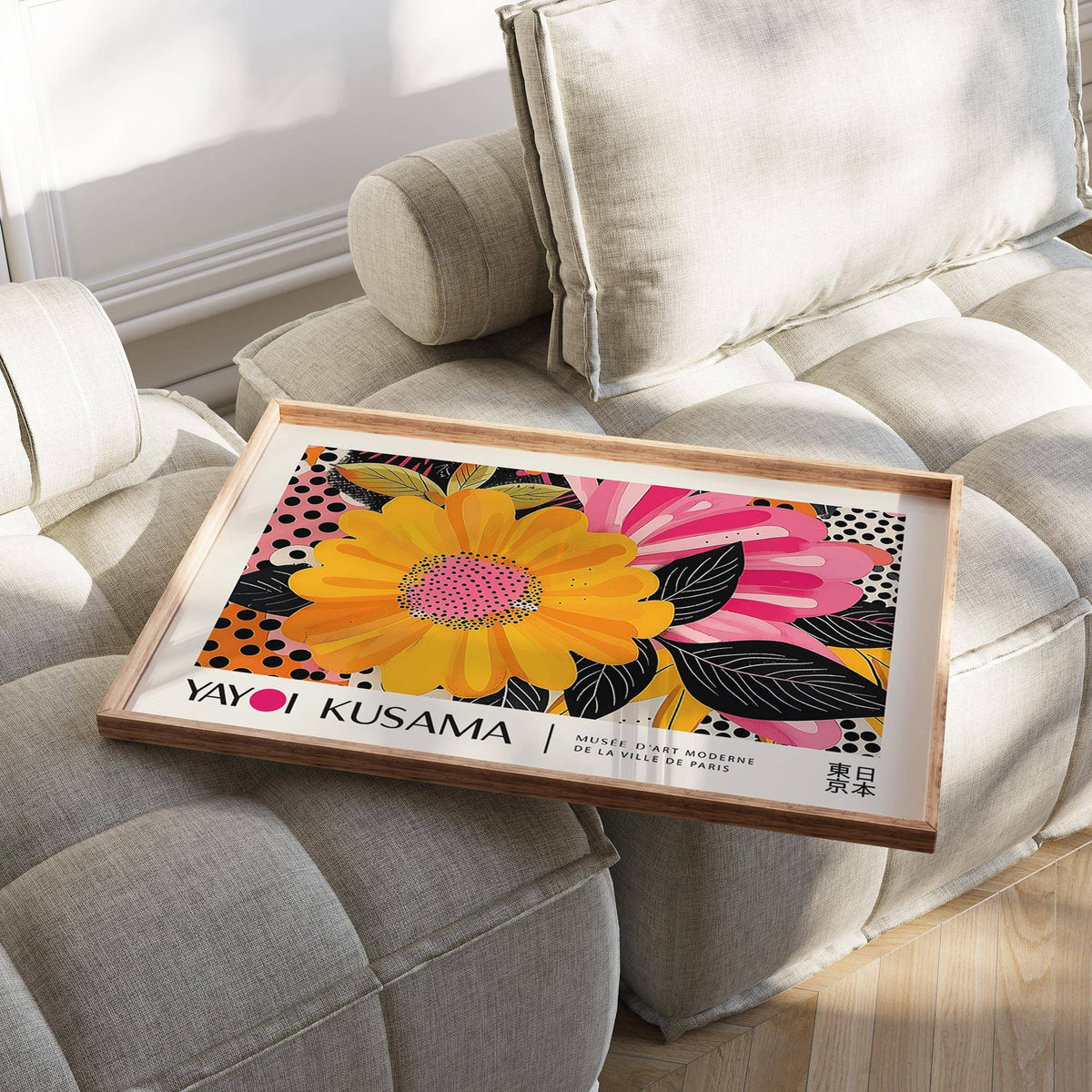 Floral Landscape Paintings print of a bright yellow and pink flower on a tray on a beige cushioned seat