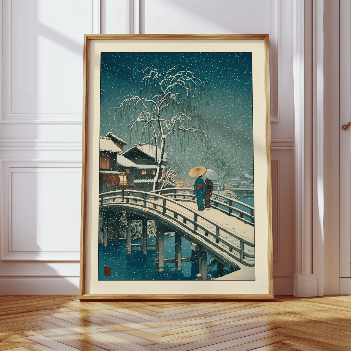 Framed close-up of Hasui Kawase Snow Print showing a snowy bridge with two people and a large tree