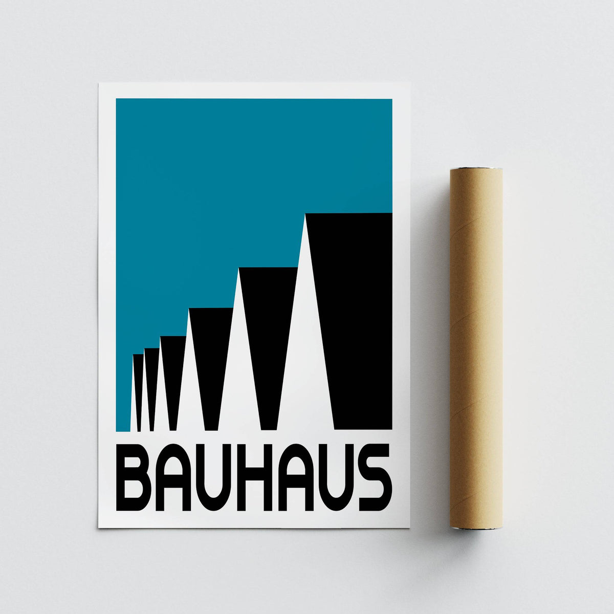 Bauhaus Poster Blue print leaning beside a cardboard packaging tube on a grey surface