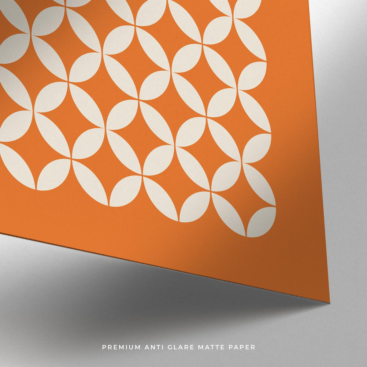 Close-up of orange poster with white circle grid pattern on matte paper