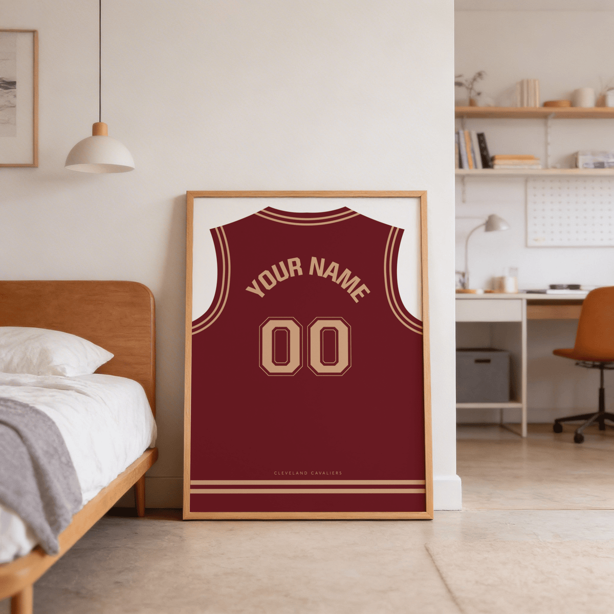 Basketball Jersey Poster in Maroon with Tan Number leaning on floor by bed in bedroom with desk