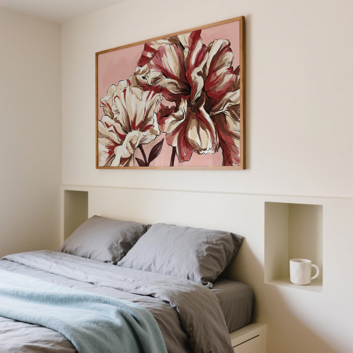Pink Background Flower Print framed print of striped flowers in red and cream above a bed with grey bedding