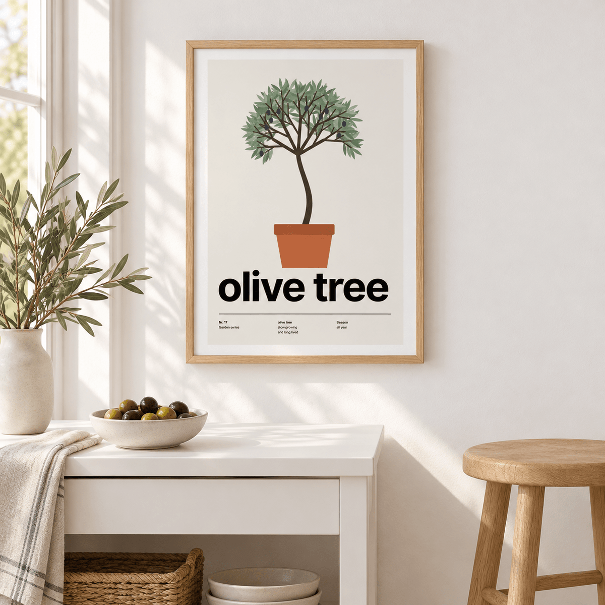 Swiss style olive tree print above a white console in a hallway