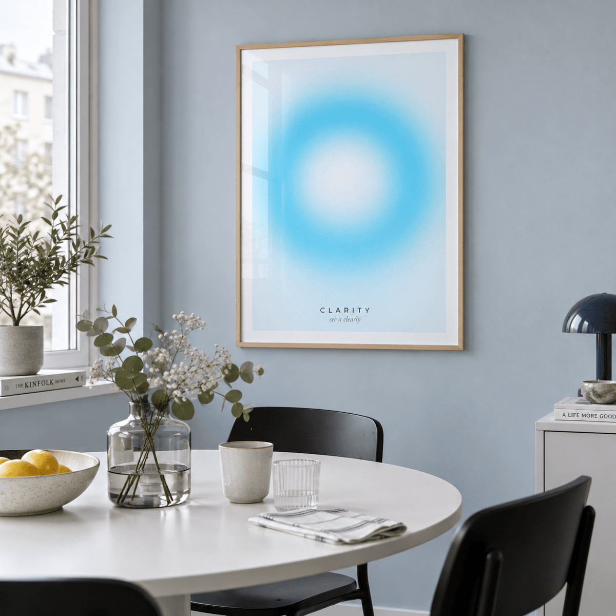 White and aqua halo print in a dining against a blue grey wall