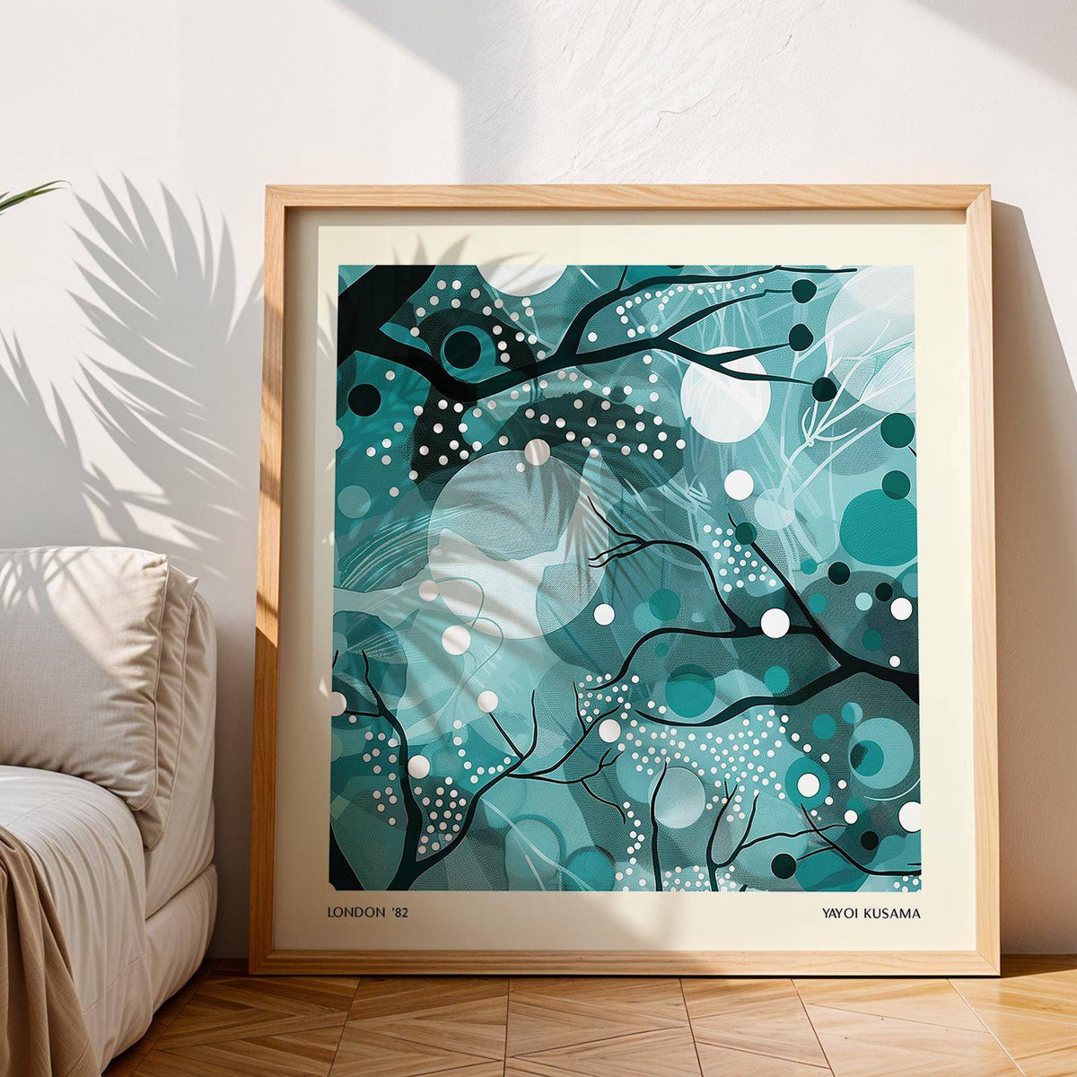 Framed teal home decor print of abstract moonlit branches in natural light leaning on wooden floor