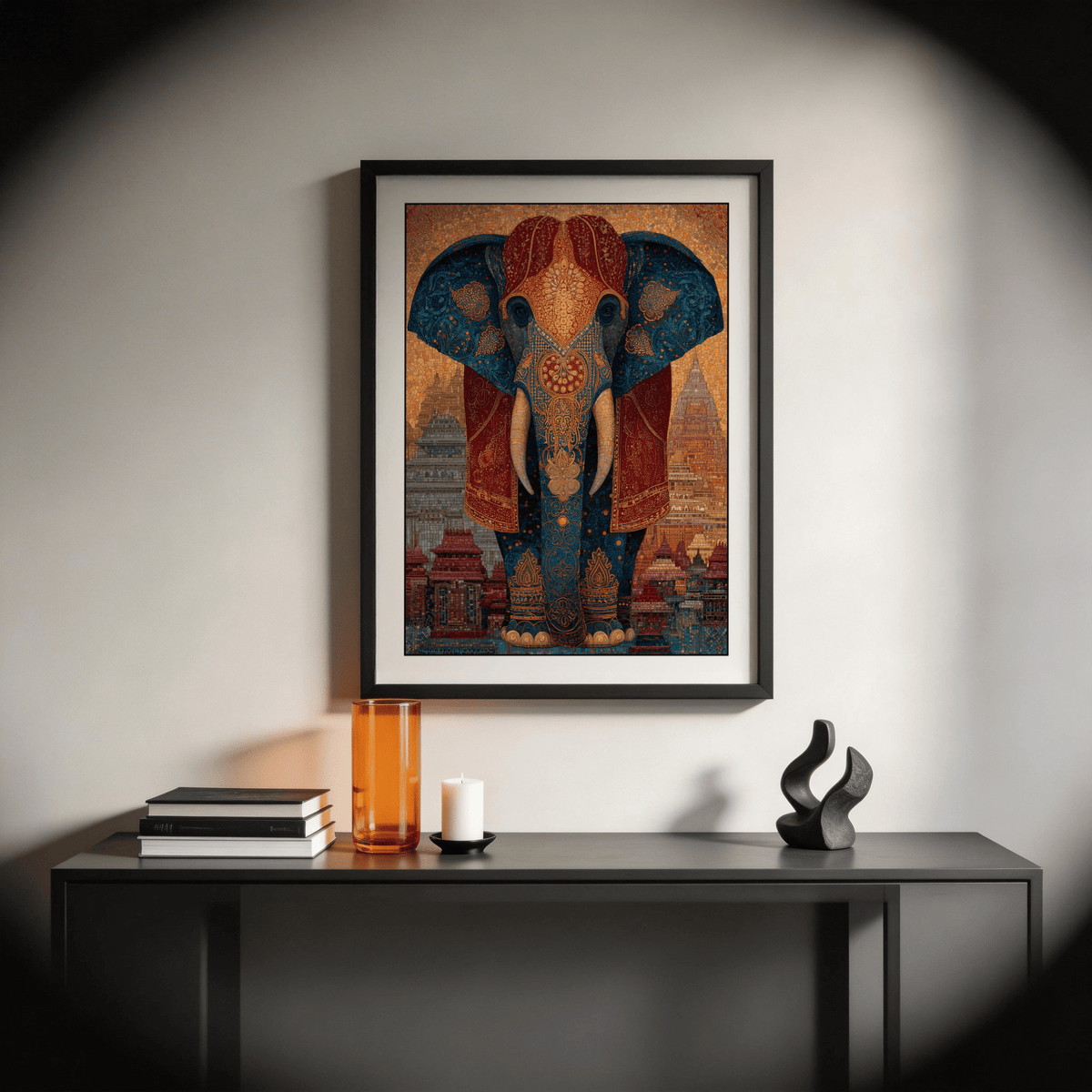 Framed colorful Indian art print of a decorated elephant in vivid blue and red above a sideboard with a tall orange vase