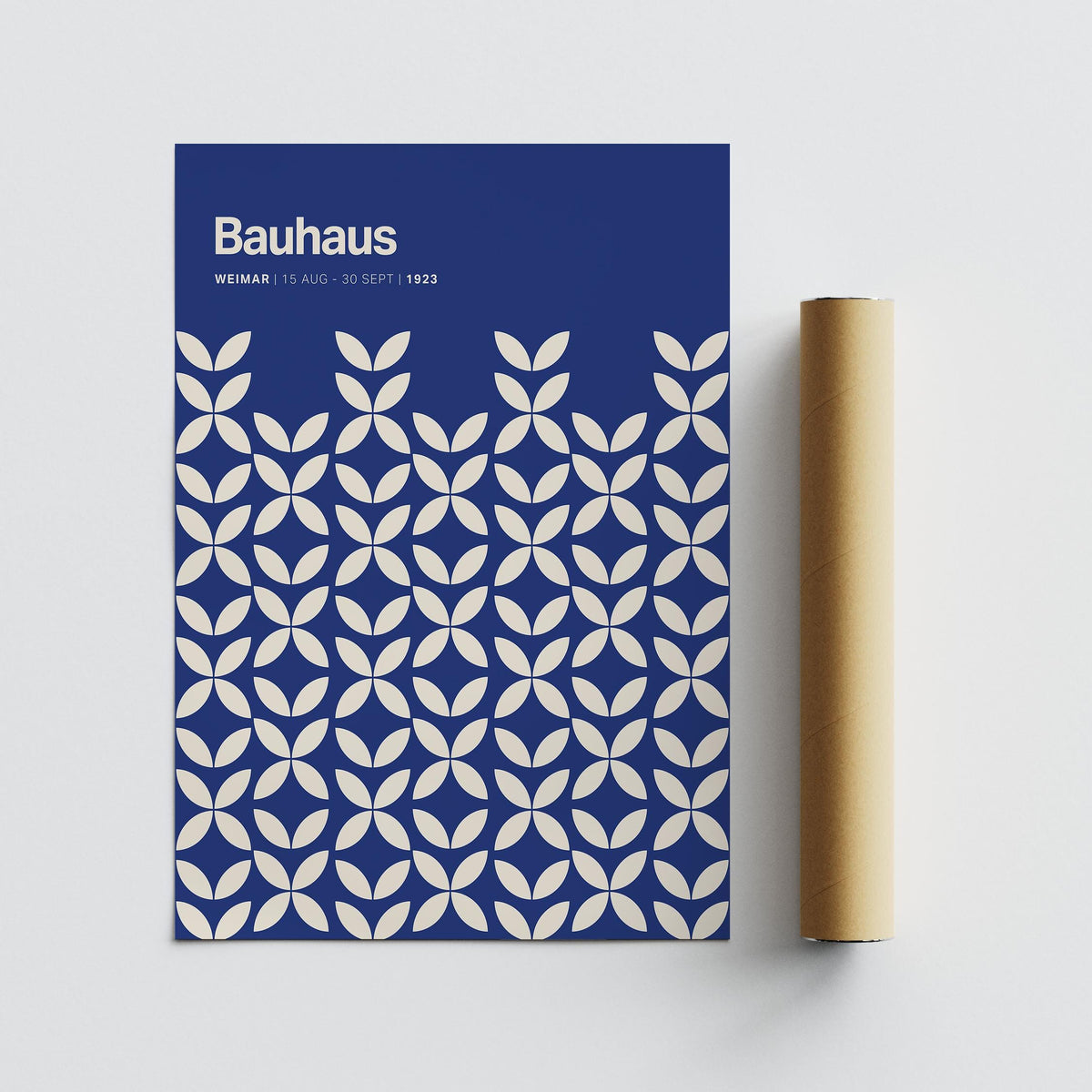 Blue modern wall art with white petal shapes alongside a brown packaging tube on a white surface