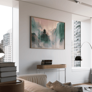 Misty Mountain Temple Art print in a living room with soft pink and green tones and books on a console table