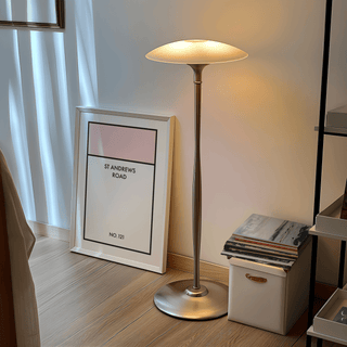 Print leaning on the floor with Street Name Family Personal minimalist typographic design by a lit floor lamp