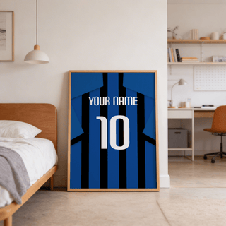 Football Shirt Poster in Blue and Black Stripes leaning against a wall beside a bed in a bedroom