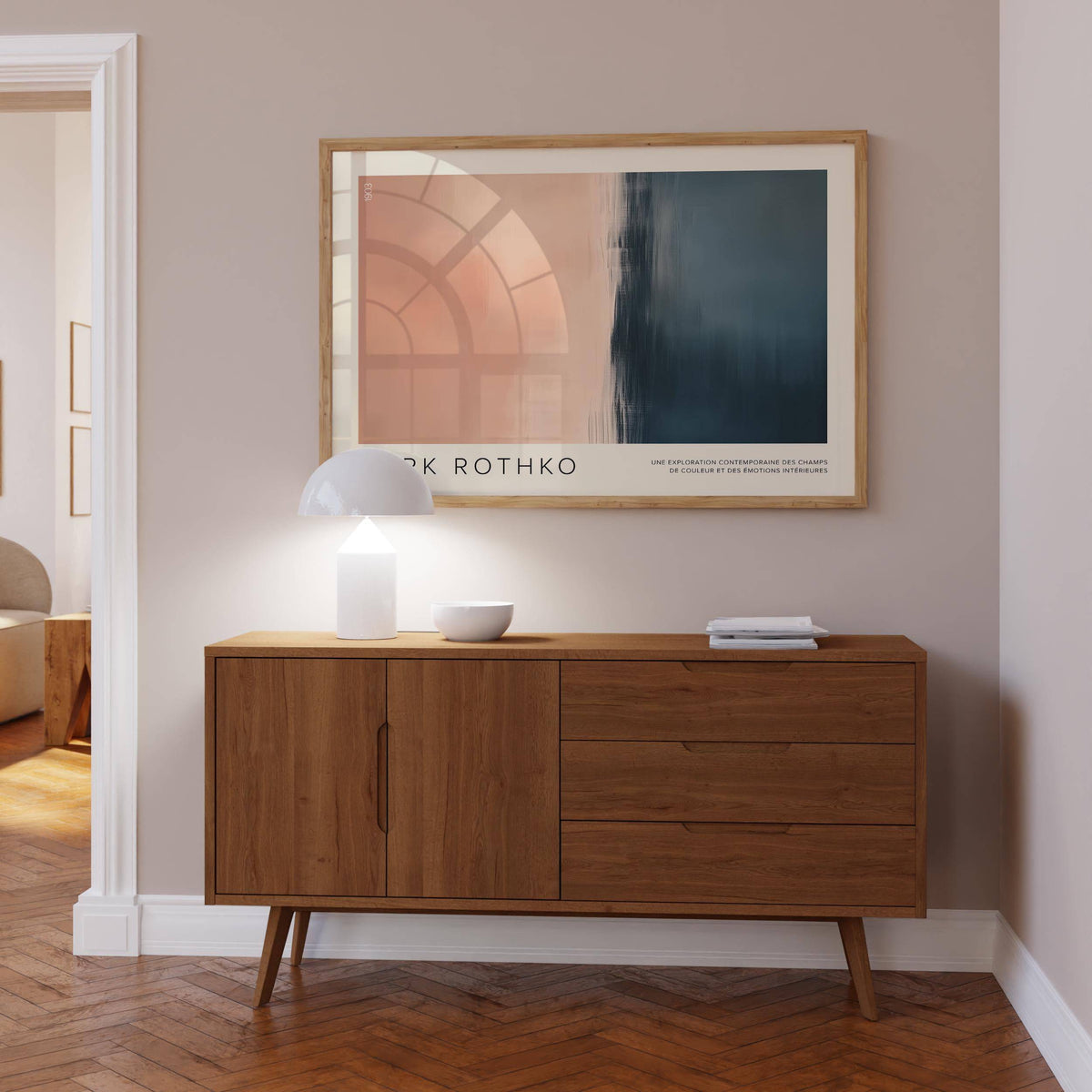 Color Block Wall Art framed print leaning above a wooden sideboard with a white lamp in a softly lit room