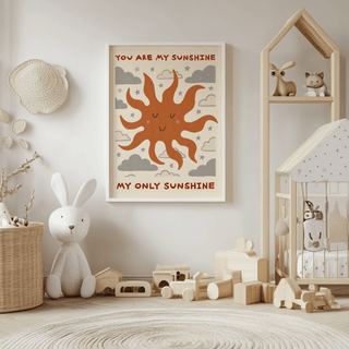 Framed Sunshine Quote Wall Art with smiling sun in muted terracotta and grey in a child's playroom with toys