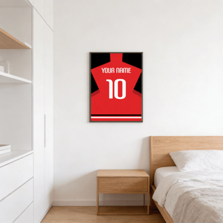 Football Shirt Poster in Plain Red with White Number hanging above a wooden bedside table in a bedroom