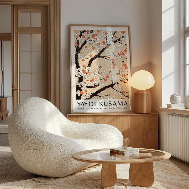 Cherry Blossom Tree art print leaning on a wooden sideboard with a round lamp and modern beige chair