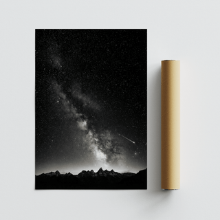 Starry Night Poster leaning alongside a packaging tube showing a night sky with milky way over dark mountain peaks