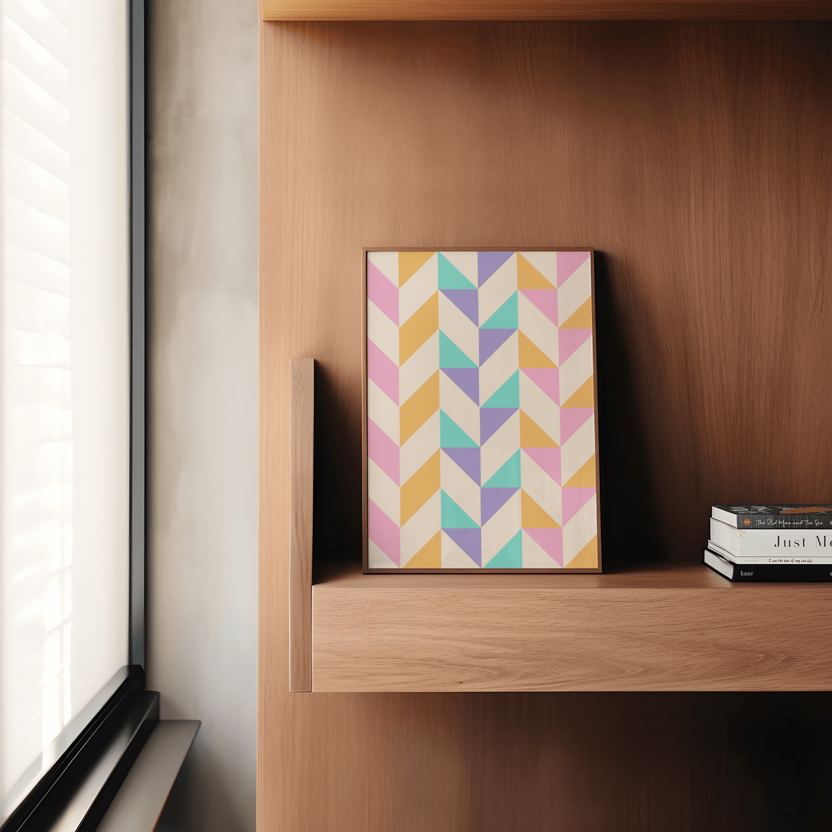 Abstract Pastel Print leaning on a wooden shelf with books nearby in natural light