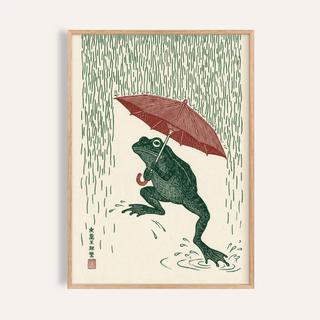 Framed Frog In Rain Art Print of a green frog under a red umbrella with vertical rain lines