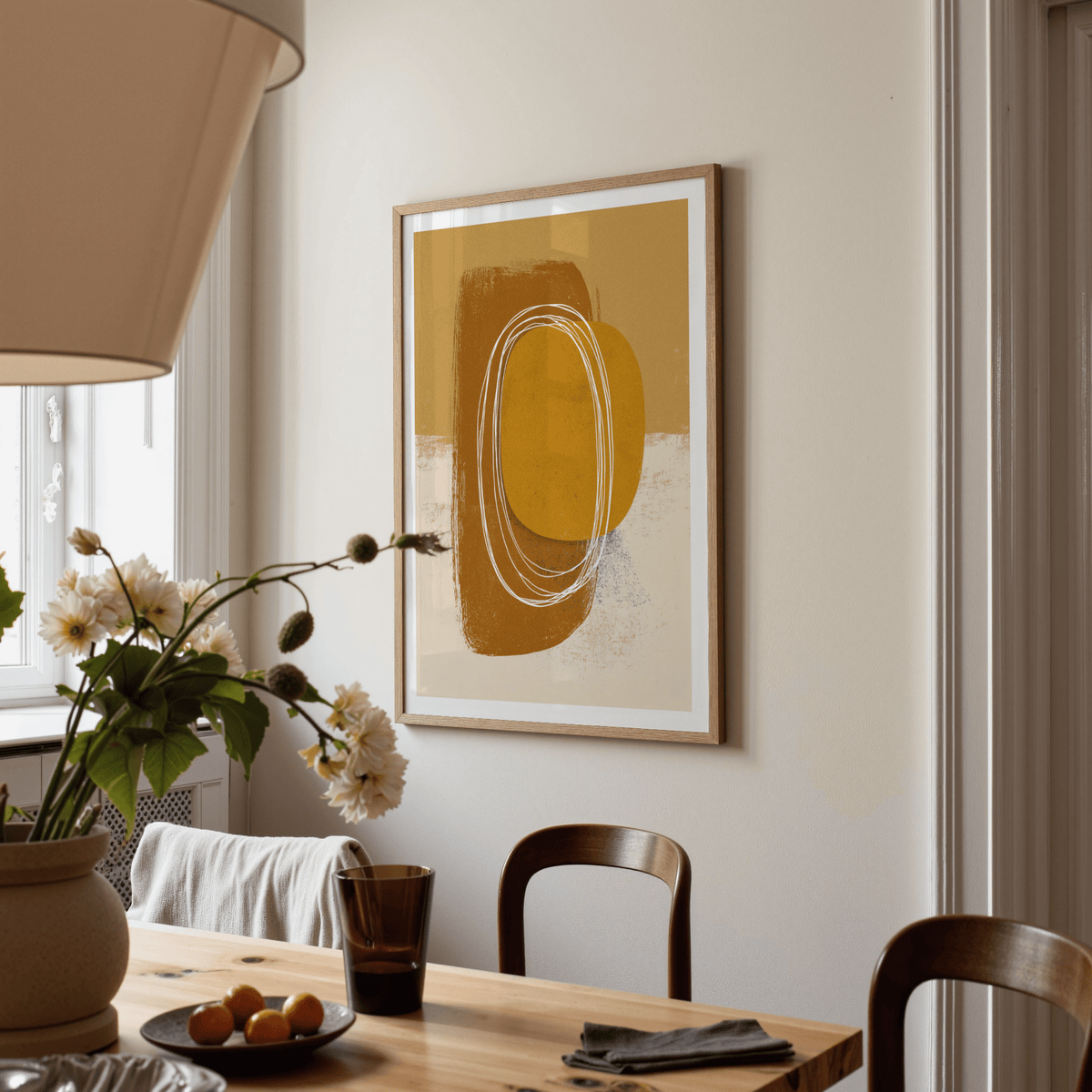 Minimalist Organic Wall Art of abstract shapes in warm ochre tones in a dining room with a wooden table