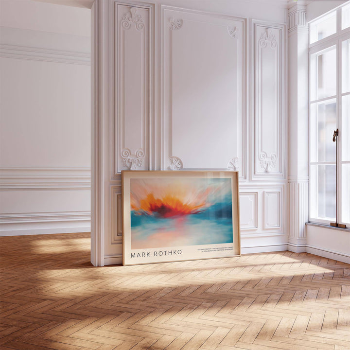 Sea Scape wall art leaning on floor with orange and blue abstract fire in a bright room