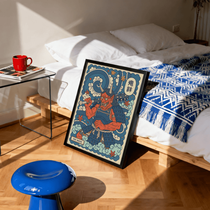 Print leaning on floor of red Japanese Oni demon with blue armour and autumn leaves by a bed with blue patterned throw