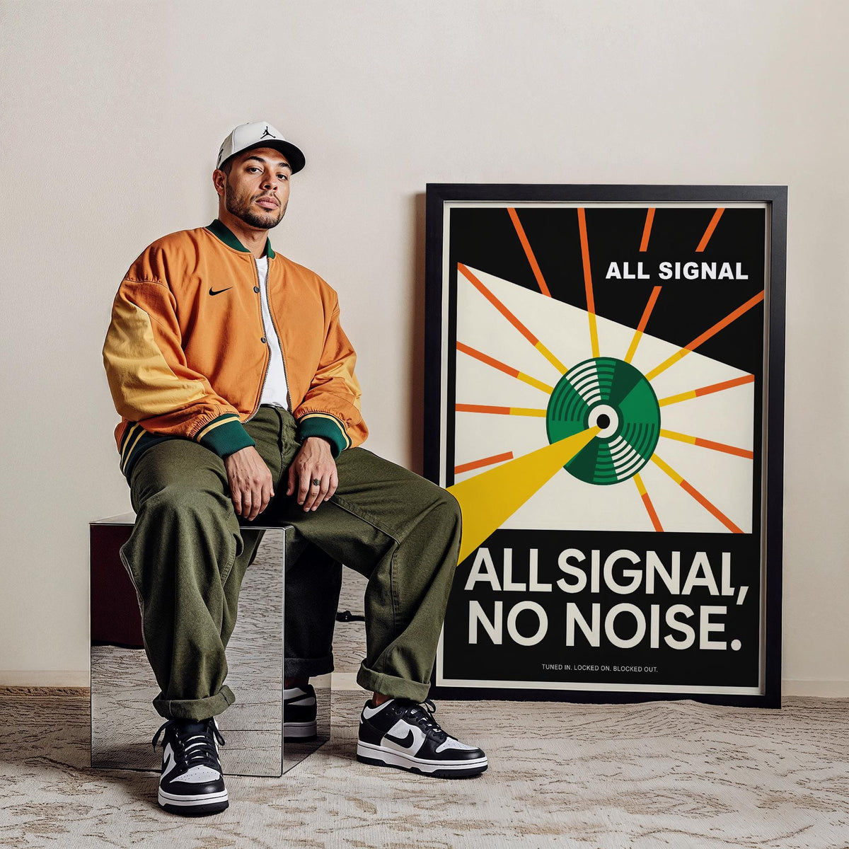 Print leaning on floor with vinyl record poster next to man in orange jacket and green trousers
