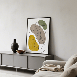Geometric Abstract Poster print leaning on a grey sideboard with a black vase and bowl nearby in a living room