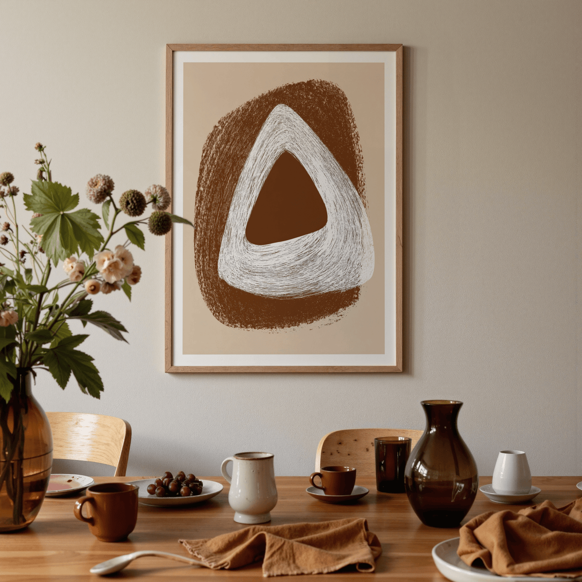 Boho Geometric Art Print with abstract brown and white triangle shapes above a dining table with dishes and a glass vase