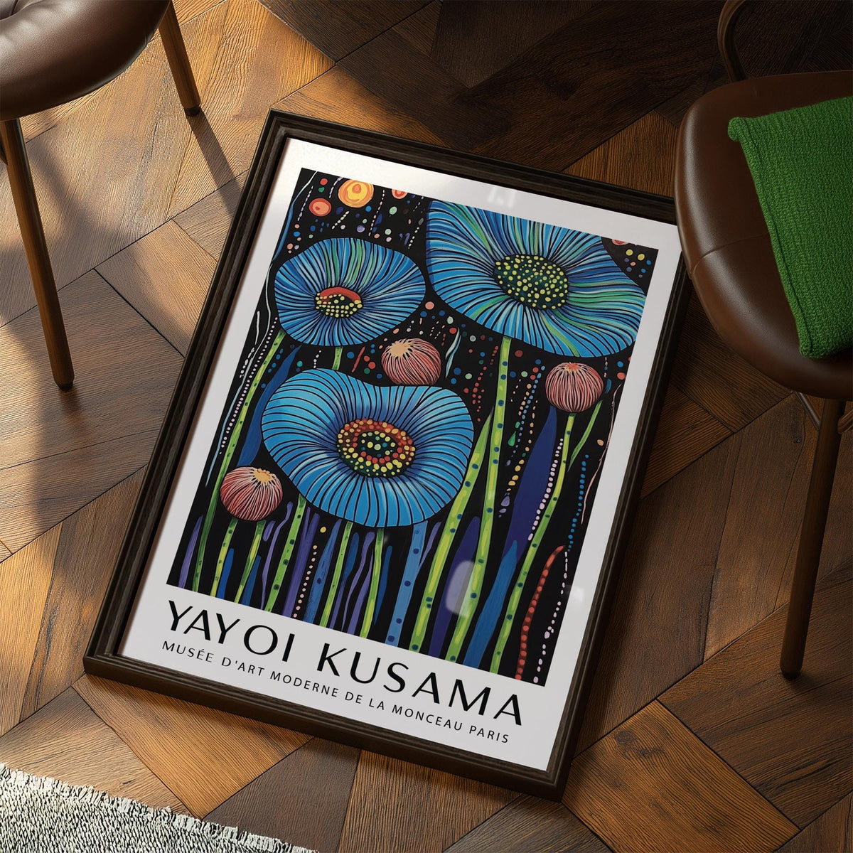 Framed print of wall art floral with blue poppy flowers and colourful stems leaning on a wooden floor