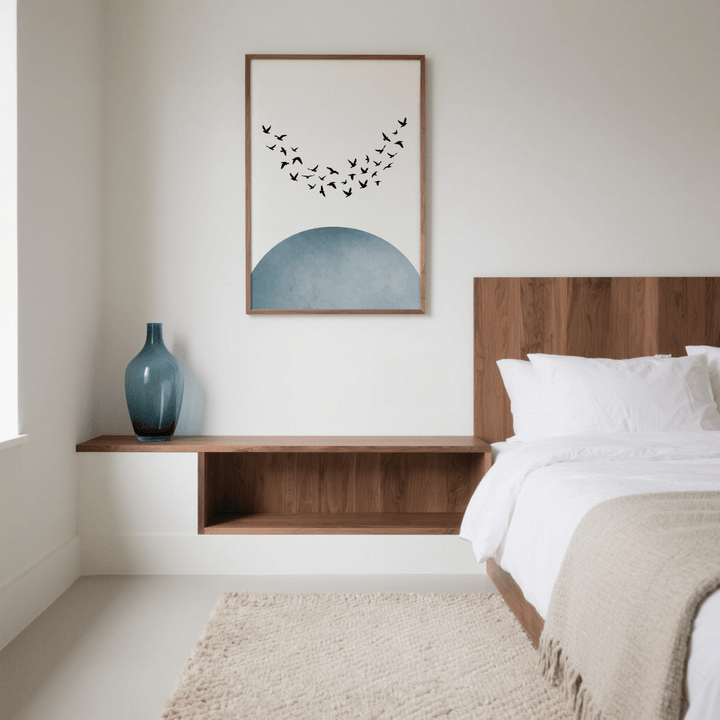 Minimal wall decor with flying bird silhouettes and blue semicircle above wooden shelf with blue vase