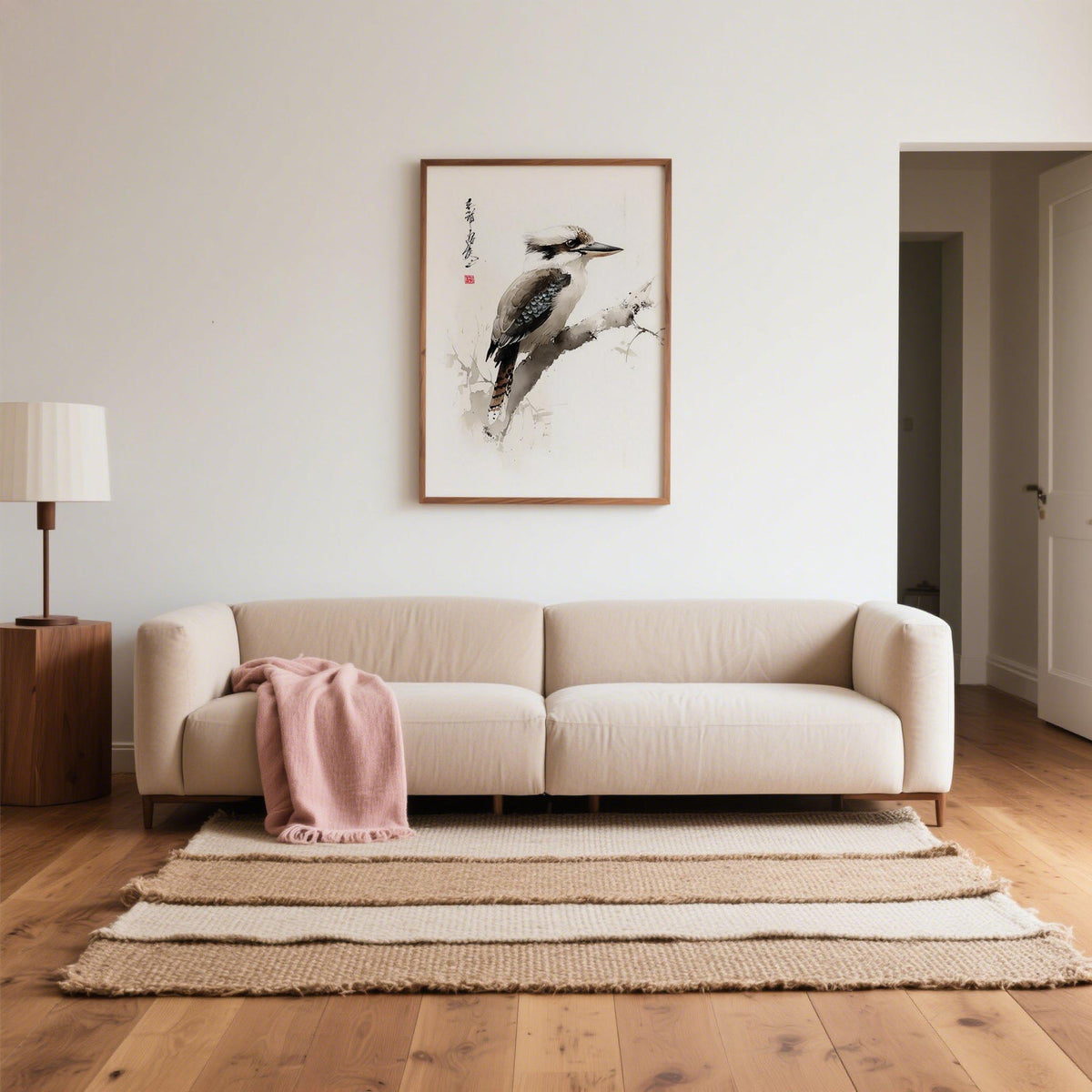 Japanese Bird Art wall art of a kookaburra bird in watercolour style above a beige sofa with a pink throw
