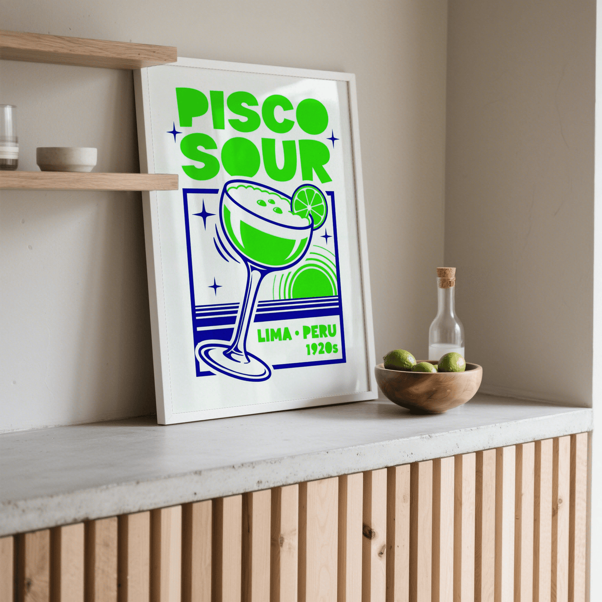 Pisco Art print leaning on a shelf with neutral beige walls and a wooden bowl nearby