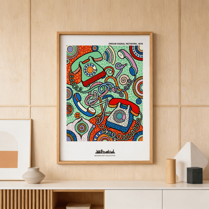 Vintage telephone art print framed on a wooden wall above a white sideboard with vases