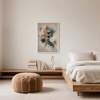 Modern Art Print on a wall with abstract blue and gold shapes above a wooden shelf with books