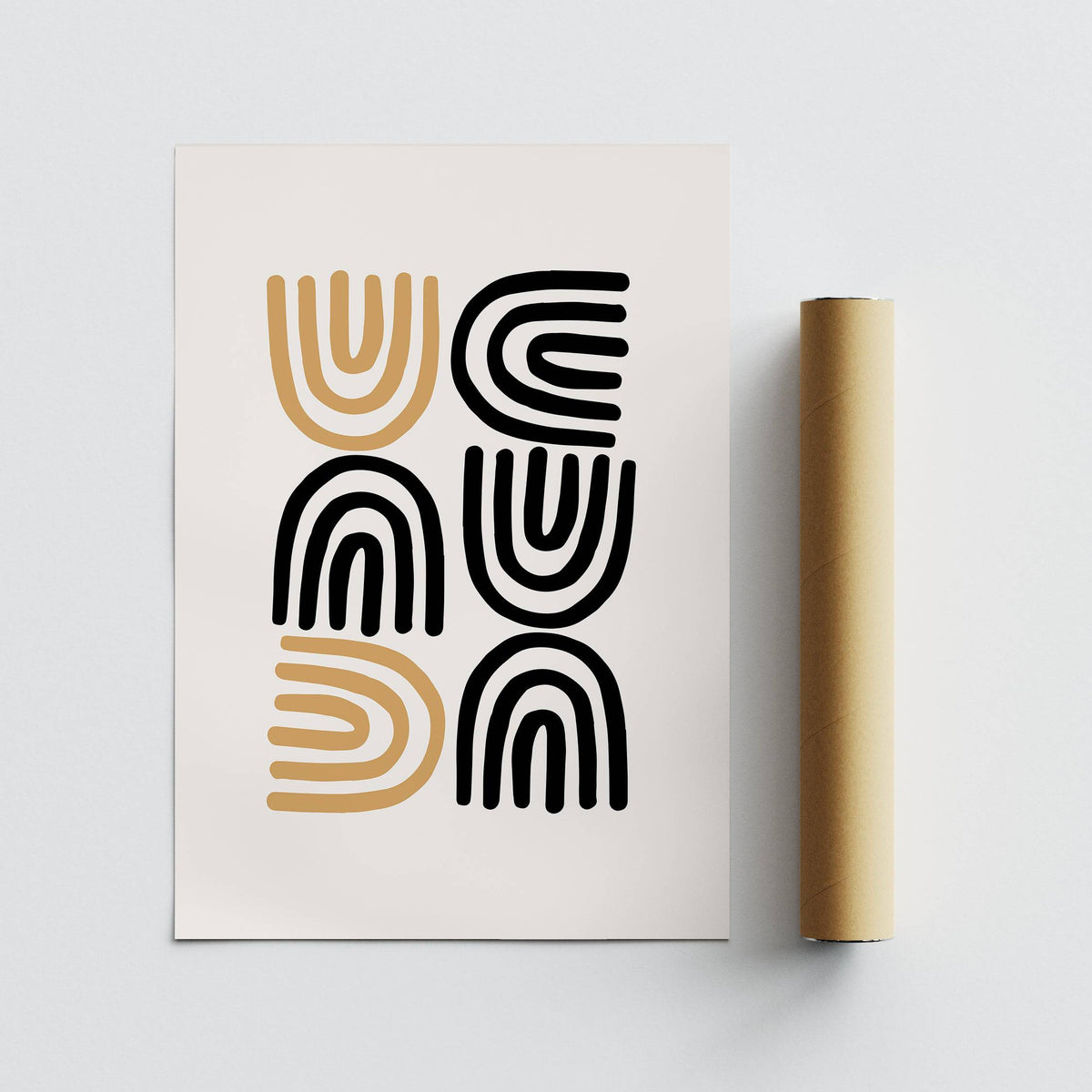 Black and Gold Pictures print with abstract black and gold arches beside a brown packaging tube on a light background
