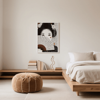 Japanese Geisha Art print on a bedroom wall above books and wooden ornament in neutral tones