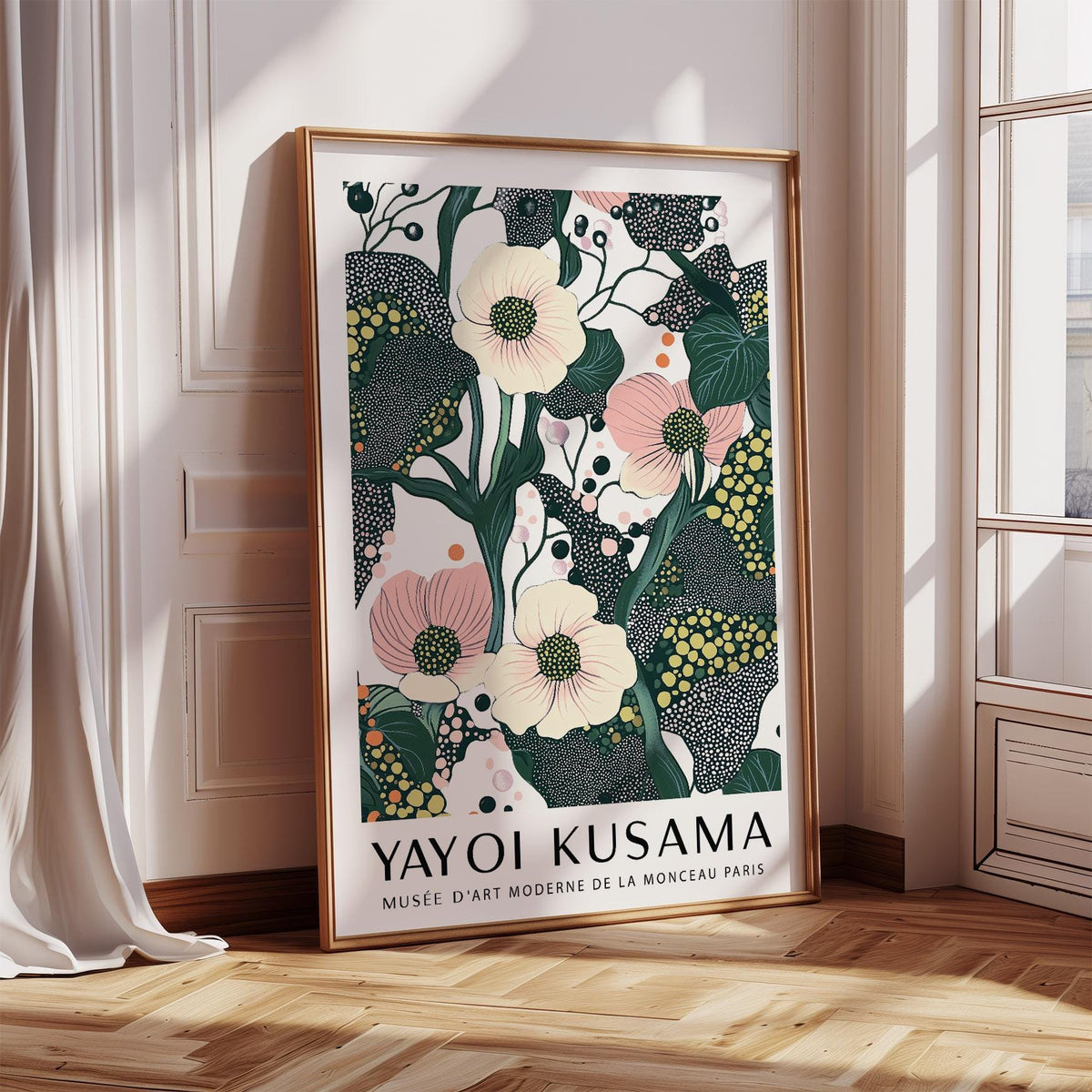 Print leaning on a floor with green and pink poppy flowers illustration beside a white wall and window