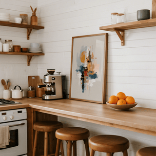 Colorful Wabi Sabi Print leaning on kitchen counter surrounded by stools and a bowl of oranges