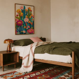 Cactus Flower art print with colourful botanical illustration above a bed with olive green bedding
