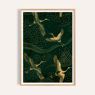 Framed print of flying cranes in gold on a dark green background with scattered gold dots