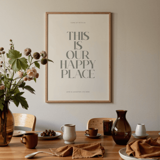 Inspirational wall sign with minimalist grey text above a dining table with cups and a vase