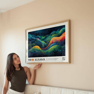 Framed horizontal abstract art with colourful flowing waves above a beige sofa