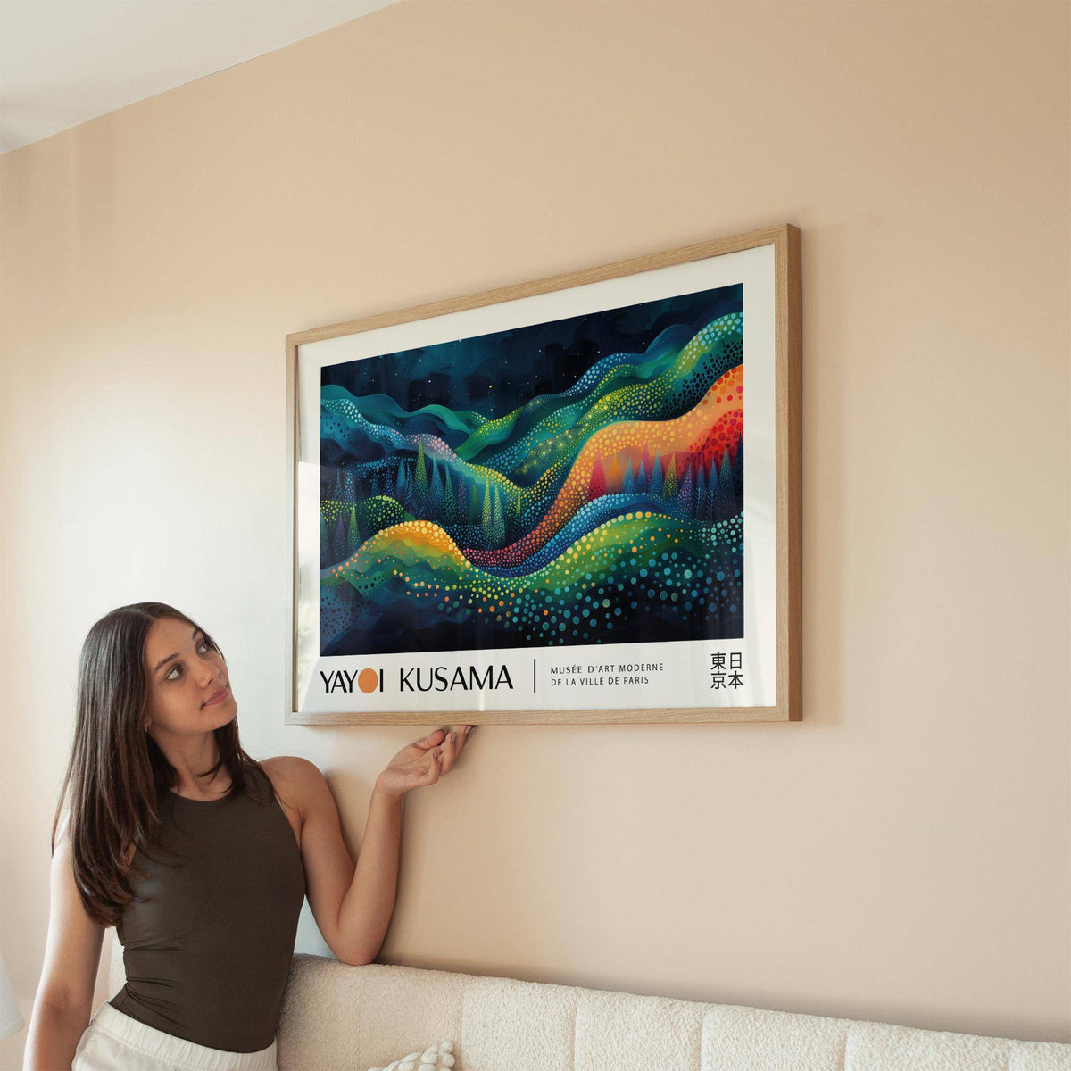 Framed horizontal abstract art with colourful flowing waves above a beige sofa